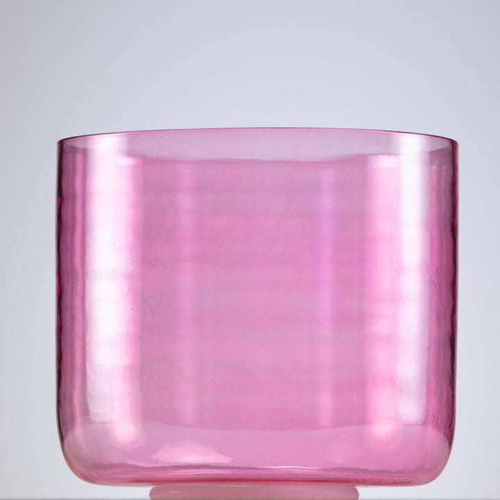 A pink quartz crystal singing bowl with a smooth, polished surface, displayed against a neutral background.