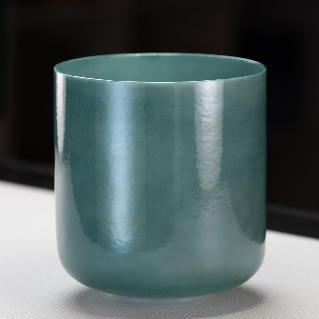 A 8-inch A#+24 Marine Dream Singing Bowl in a pearlescent blue-green color from Sacred Singing Bowls