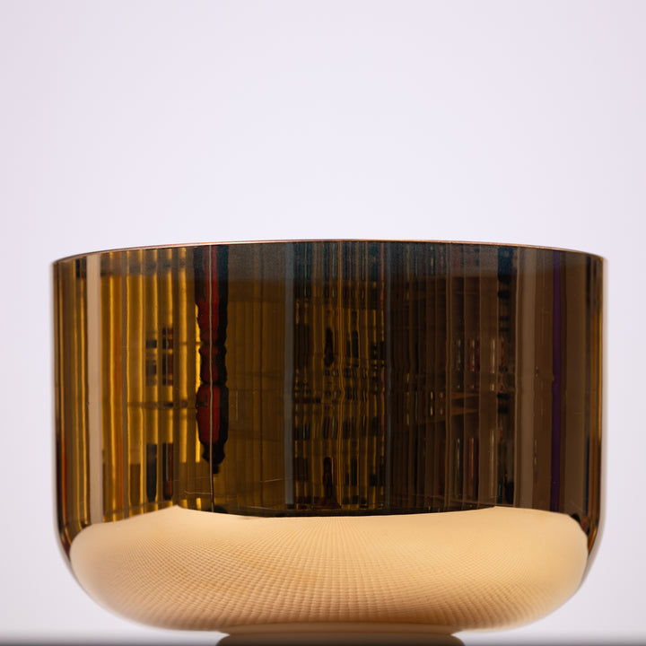 A 9.75 inch C+40 24k Gold Crystal Singing Bowl with a reflective gold surface and a light brown base, set against a white background.