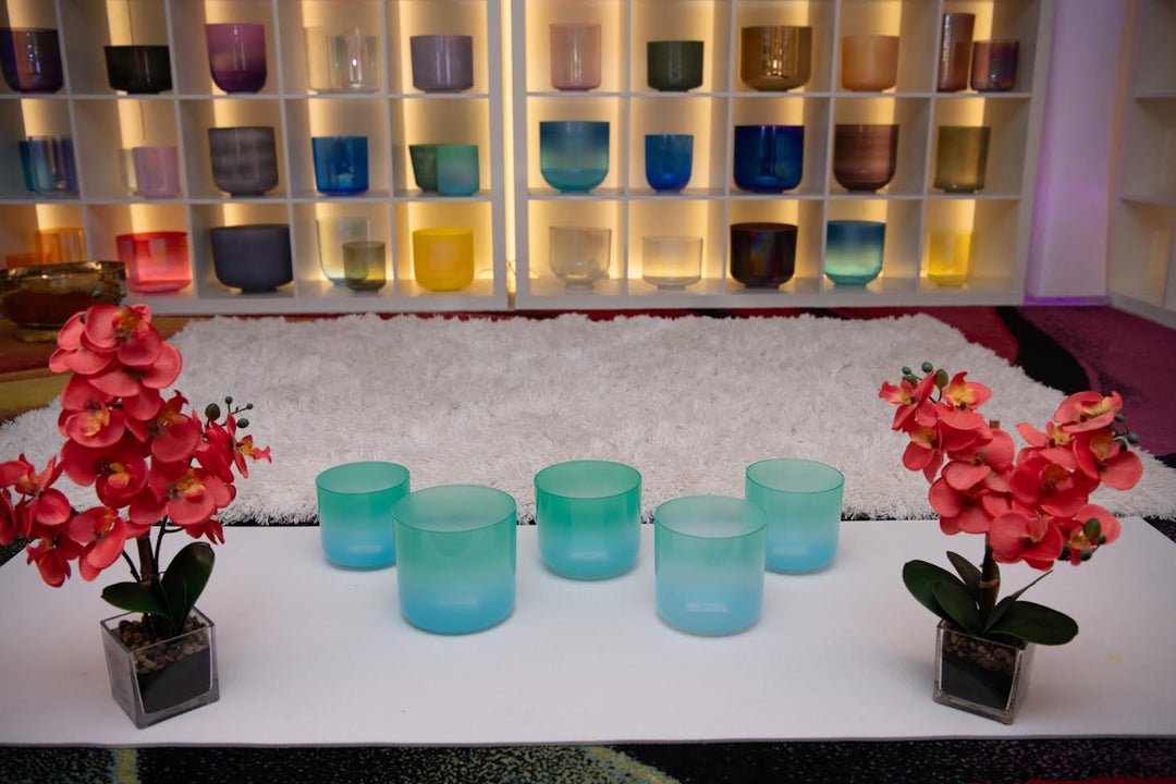 A set of five turquoise and light green crystal singing bowls from Sacred Singing Bowls.