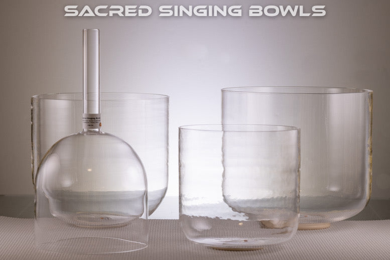 A set of clear quartz singing bowls in various sizes, displayed against a neutral background with the text 'SACRED SINGING BOWLS' at the top.