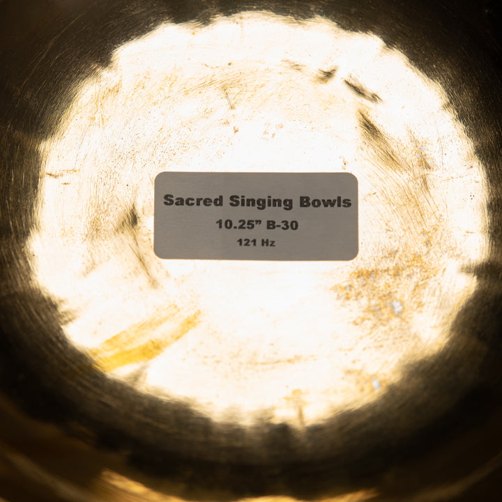 Close-up of a Sacred Singing Bowls™ logo with a label indicating size and frequency.