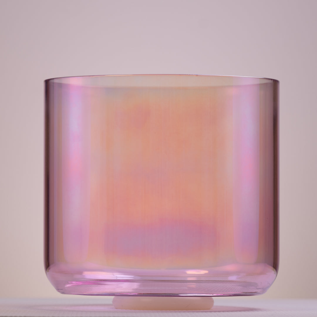 A 10.25-inch E+40 Solar Violet Singing Bowl with a light pink hue, displaying its unique shape and color.