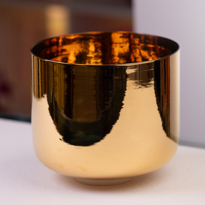 A 10 inch E-20 24k gold and crystal singing bowl with a reflective golden finish.