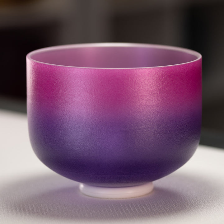 A 10 inch frosted crystal singing bowl with pink and purple hues, and a silver interior.