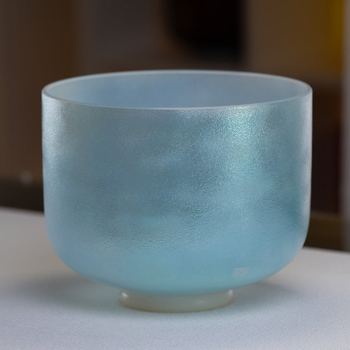 A 10 inch G+40 Aqua Aura Gold Super Grade Crystal Singing Bowl with a glossy finish.