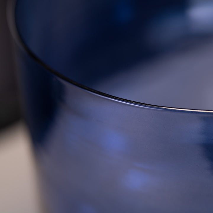 Close-up of a blue crystal bowl with a blurred background