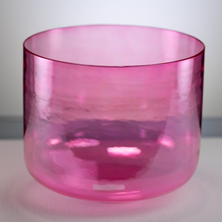 A polished pink singing bowl with a smooth, cylindrical shape, displayed against a neutral background.