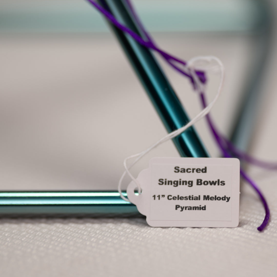 Singing pyramid with a label indicating 'Sacred Singing Bowls 11" Celestial Melody Pyramid' on a light background.