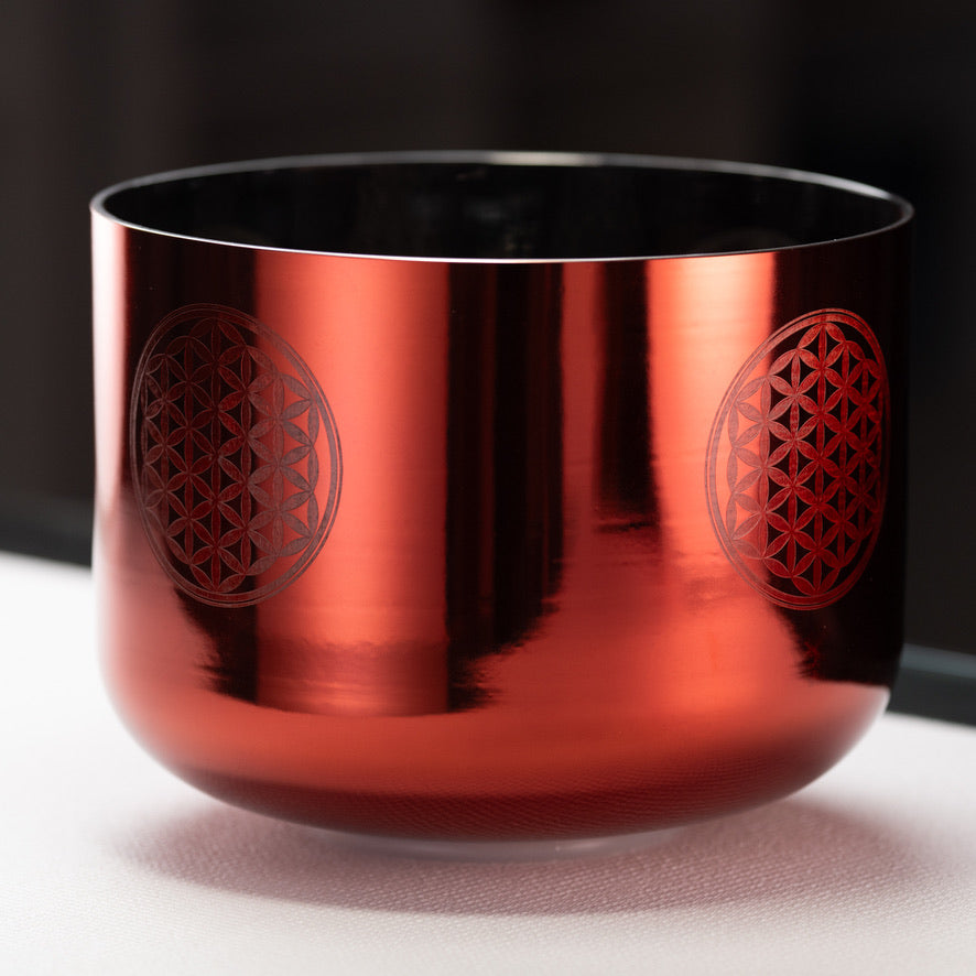 An 11 inch orange crystal singing bowl with Flower of Life engraving on the sides.