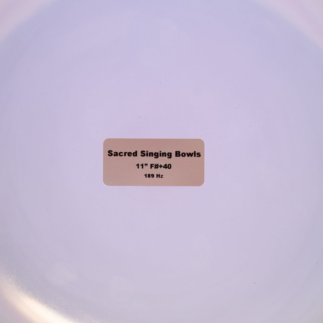 Label on a white surface indicating 'Sacred Singing Bowls' with dimensions and frequency details.