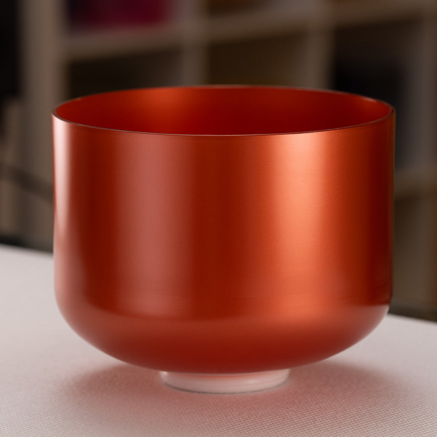 An 11 inch G#+43 Copper Connection crystal singing bowl with a smooth, reflective surface, displayed against an blurred background.