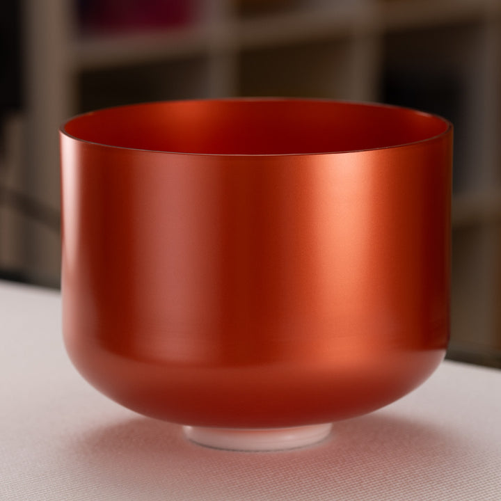 An 11 inch G#+43 Copper Connection crystal singing bowl with a smooth, reflective surface, displayed against an blurred background.