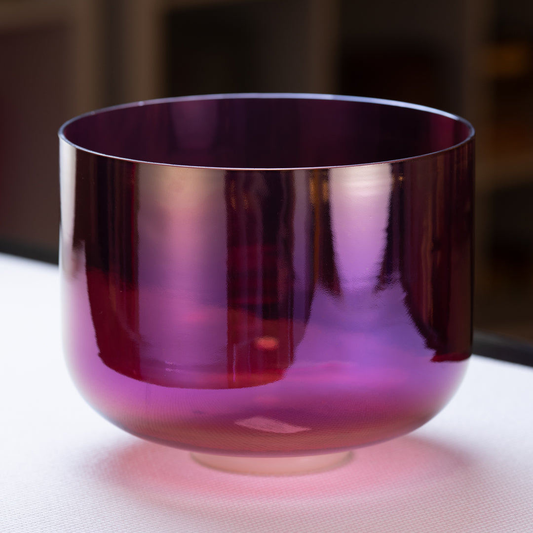 An 11-inch G+8 Healing Violet Flame Crystal Singing Bowl with a prismatic surface and a deep purple color from Bowls of Sound.