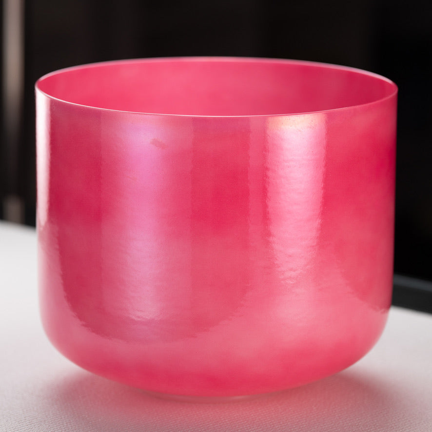 A 12-inch pearlescent pink singing bowl, made from quartz crystal, displayed against a dark background.