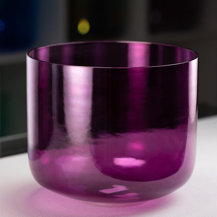 A 12-inch dark purple healing violet flame crystal singing bowl on a wooden surface, with a blurred background.