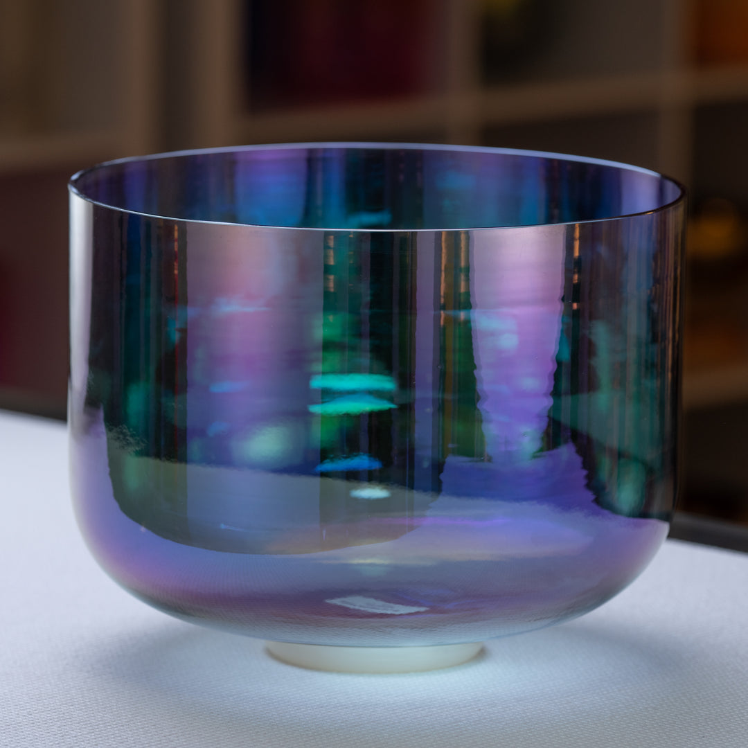 A 12-inch F+11 Aurora Sky Crystal Singing Bowl with a vibrant indigo color, displayed on a stand.