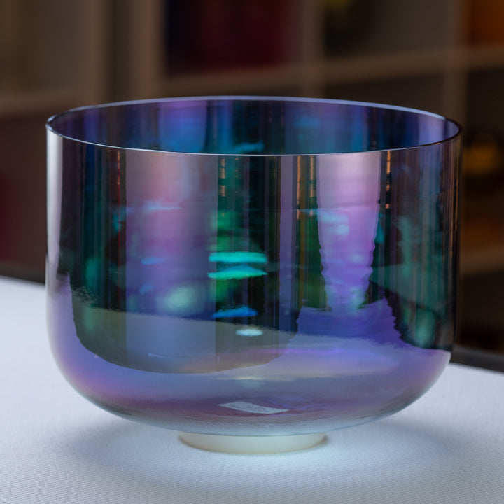 A 12-inch F+11 Aurora Sky Crystal Singing Bowl with a vibrant indigo color, displayed on a stand.