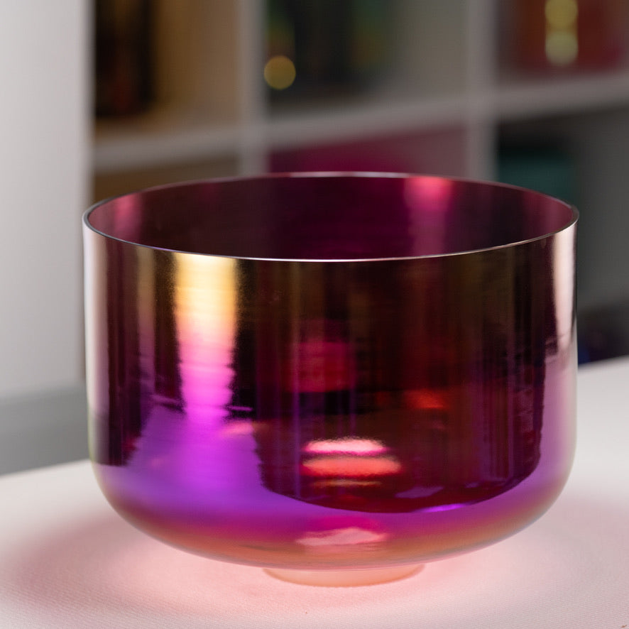 Purple reflective bowl on a white surface with a blurred background