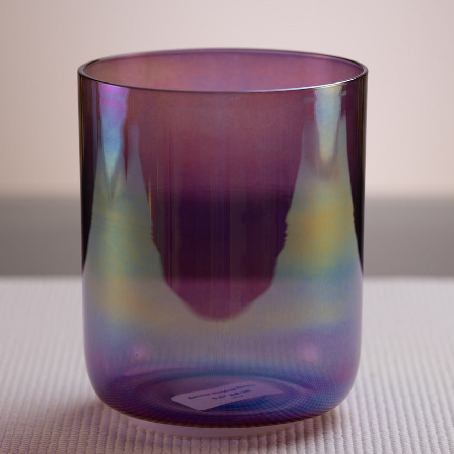 A#-38 Amethyst Activation Crystal Singing Bowl, Prismatic, with a dark purple color and a reflective surface, displayed on a white textured surface.