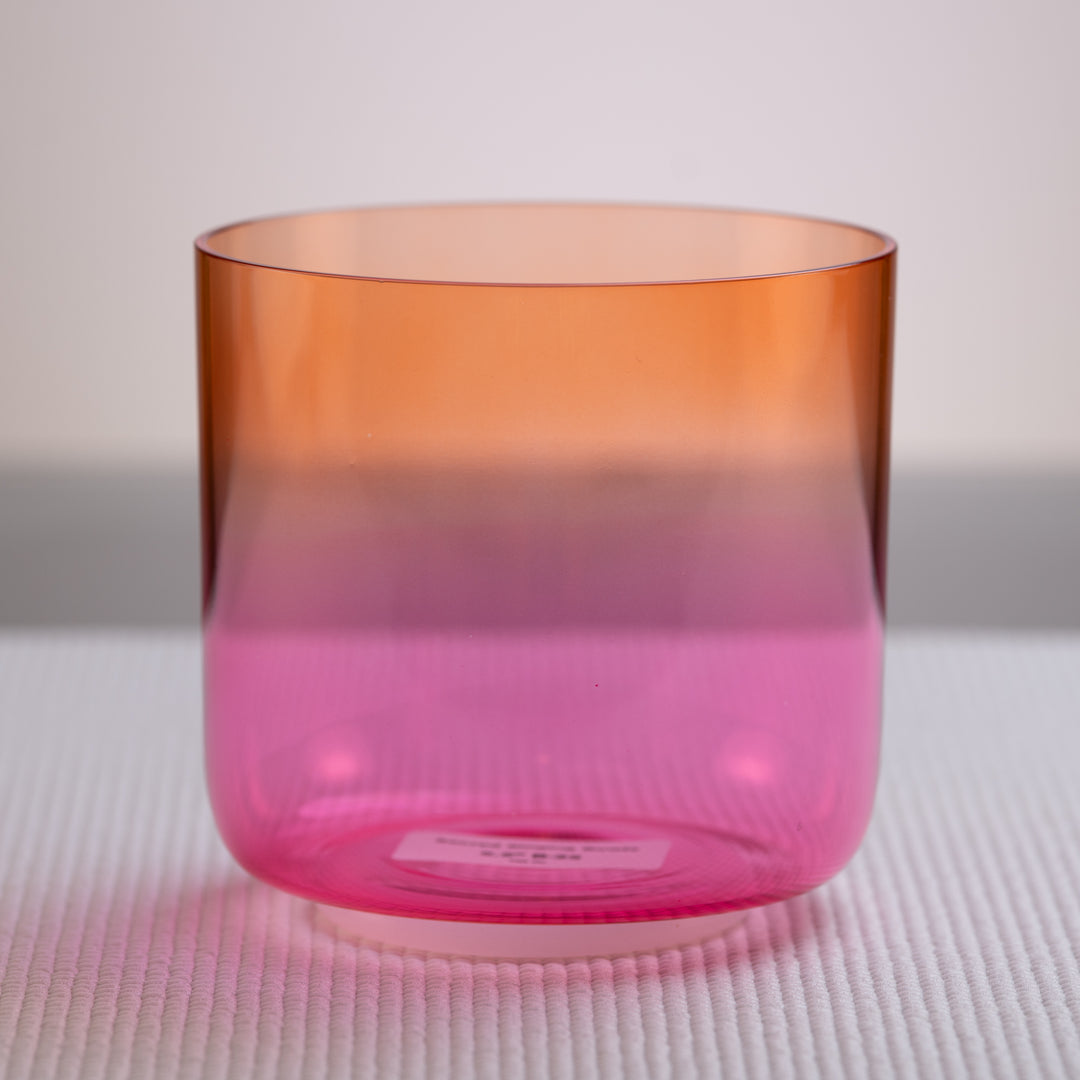 A 5.5-inch orange & pink crystal singing bowl on a white background.