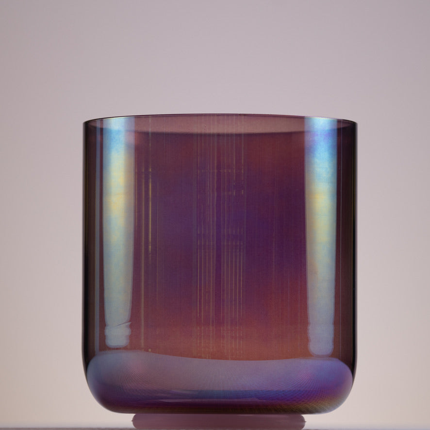 A 5.75 inch crystal singing bowl with a prismatic, amethyst color.