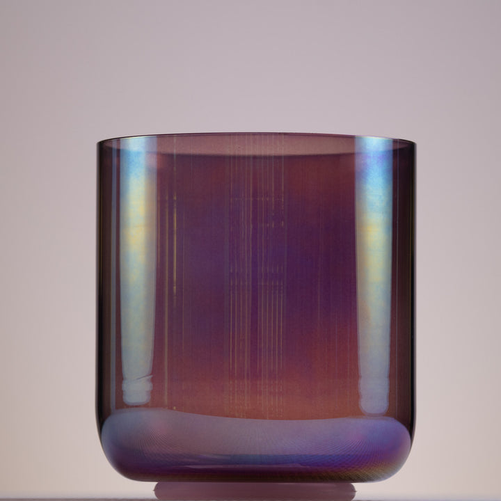 A 5.75 inch crystal singing bowl with a prismatic, amethyst color.