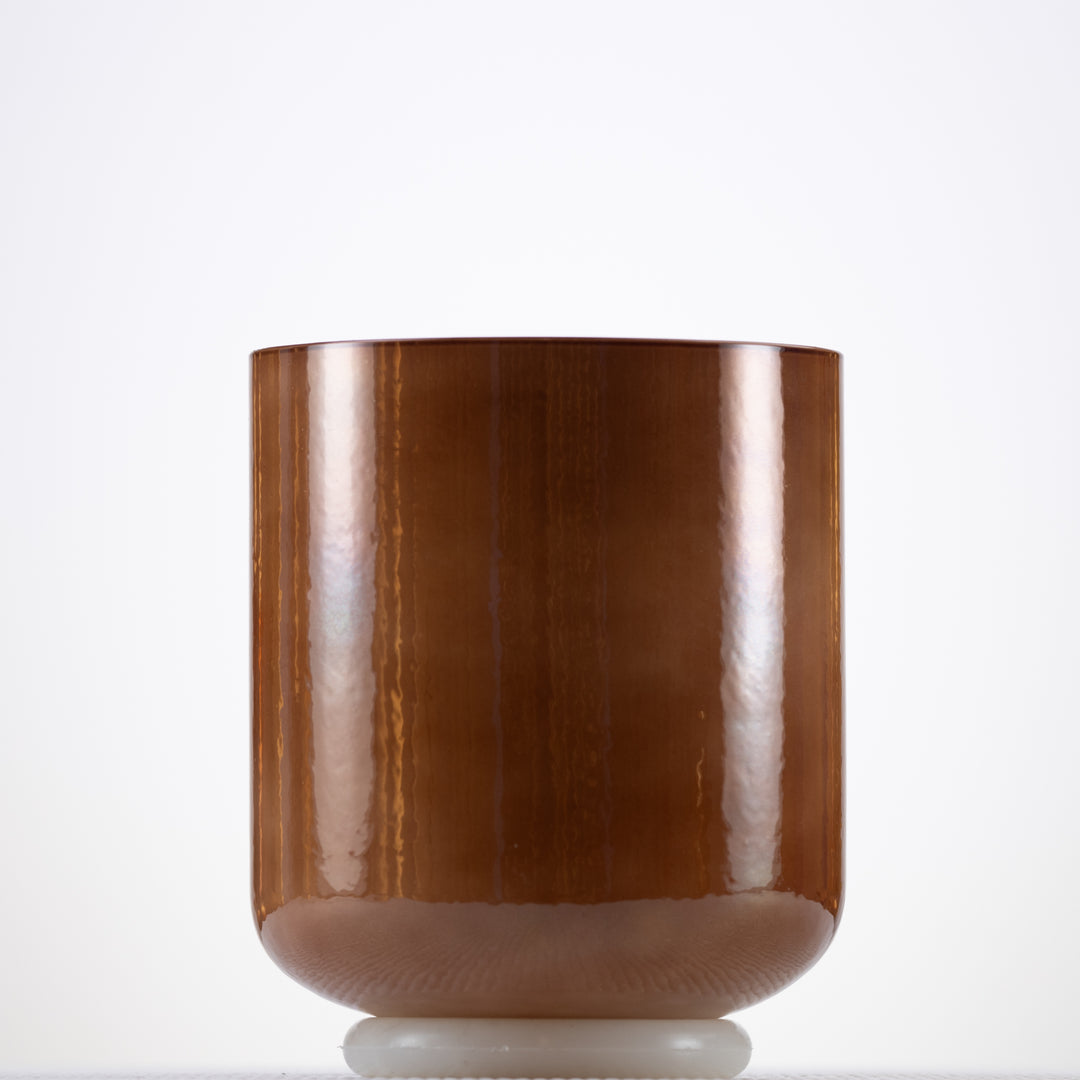 A light brown crystal singing bowl with a smooth, pearlescent surface, displayed against a white background.