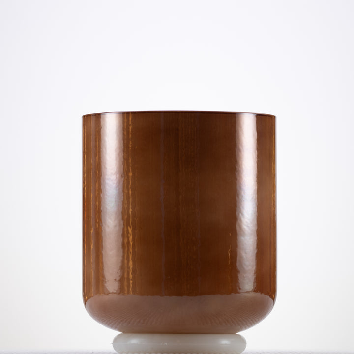 A light brown crystal singing bowl with a smooth, pearlescent surface, displayed against a white background.