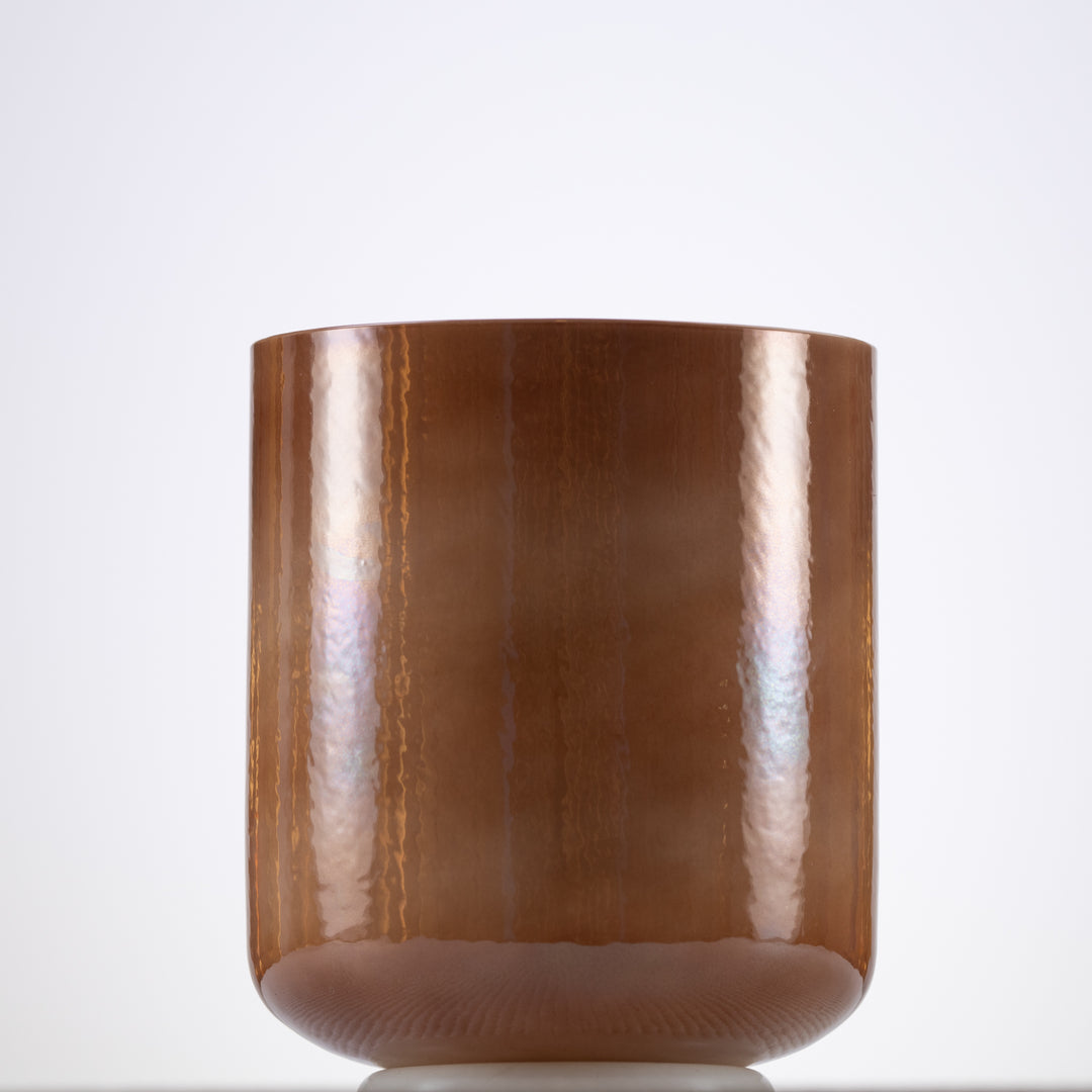A 6.5 inch F#-43 Desert Hymn Crystal Singing Bowl with a pearlescent, light brown color.