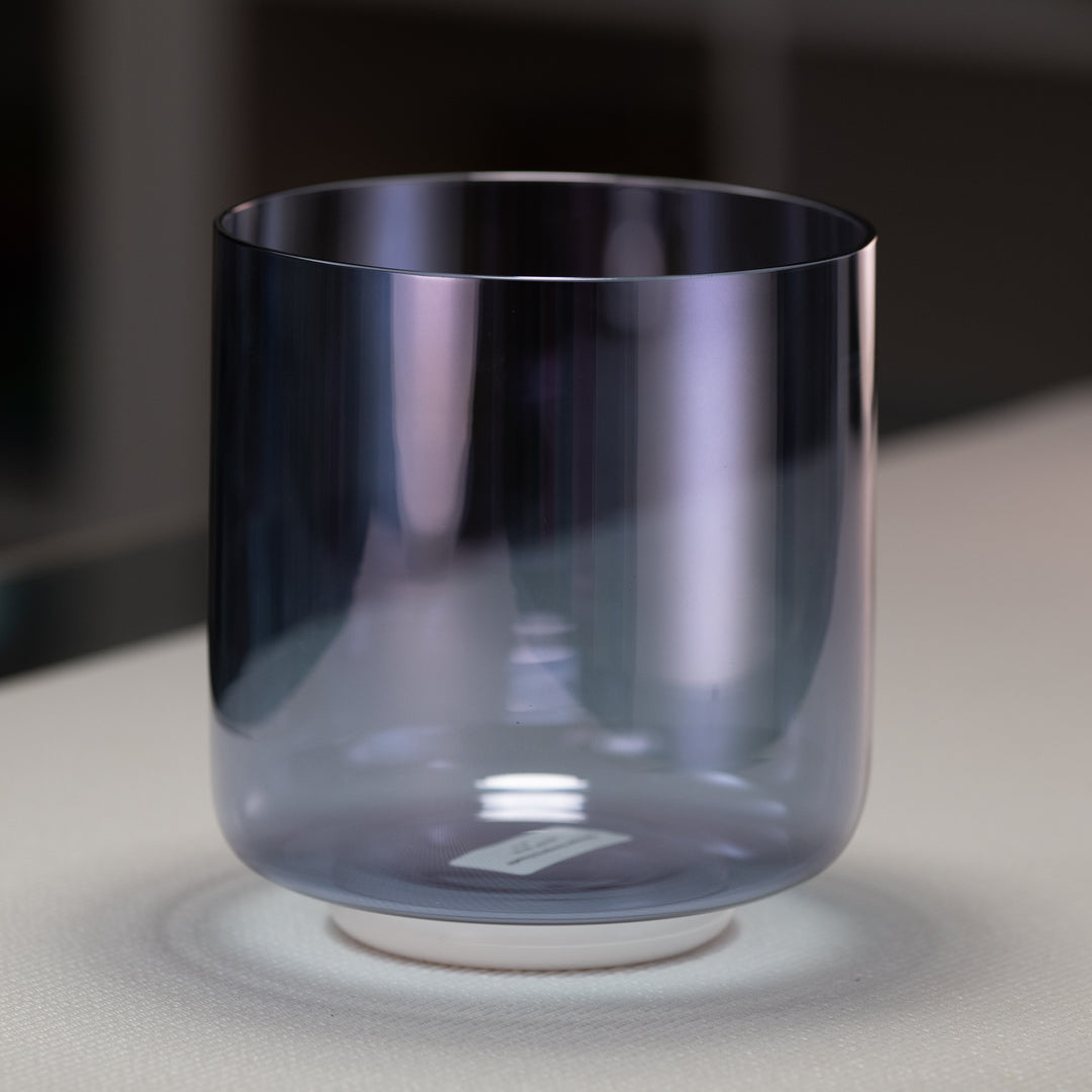 A 6.75" D+41 Indigo Child Crystal Singing Bowl with a smooth, round shape and a gradient of blue to purple color.