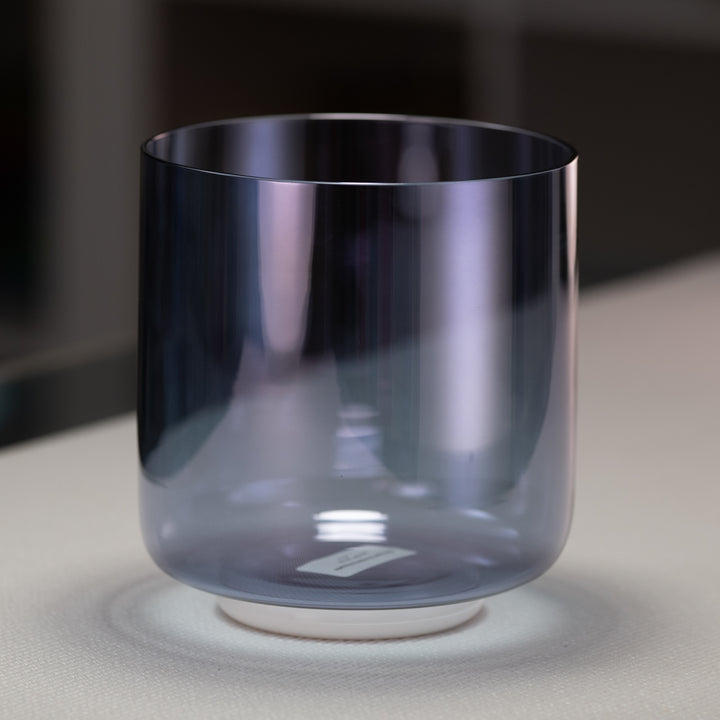 A 6.75" D+41 Indigo Child Crystal Singing Bowl with a smooth, round shape and a gradient of blue to purple color.