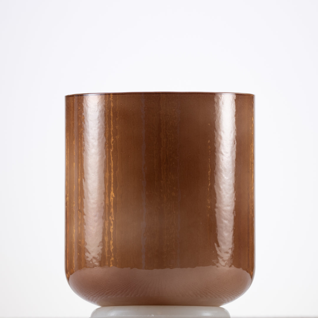 A light brown, pearlescent crystal singing bowl with a smooth, glossy finish.