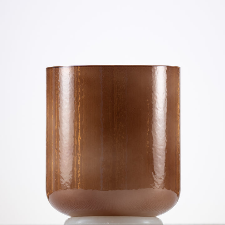 A light brown, pearlescent crystal singing bowl with a smooth, glossy finish.