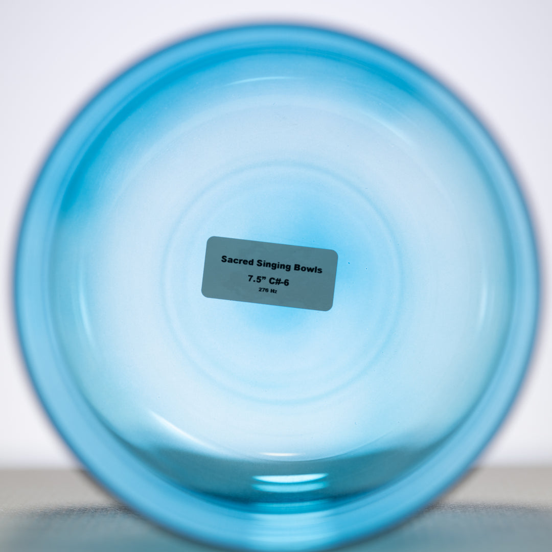 A 7.5 inch Caribbean Blue Crystal Singing Bowl with a label indicating it is 'Sacred Singing Bowls™