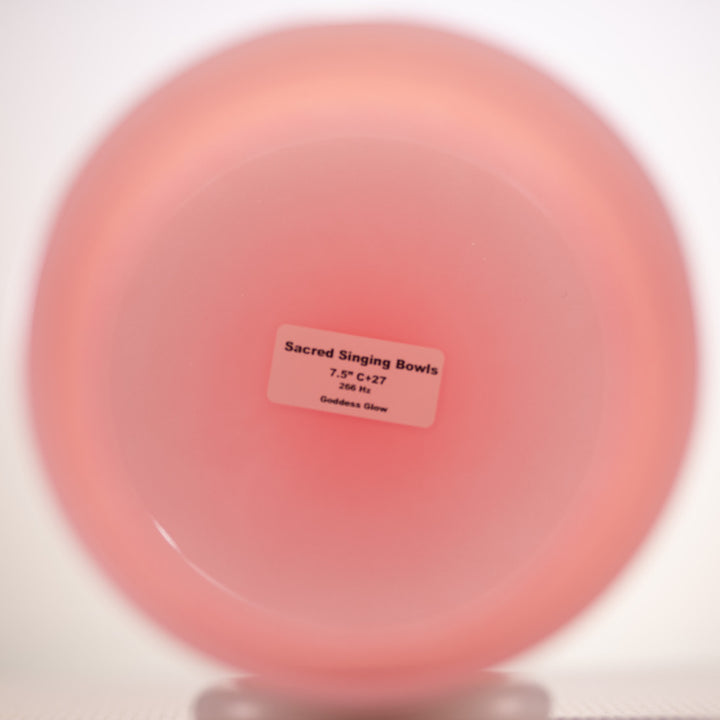 Pink singing bowl with a label on a white background