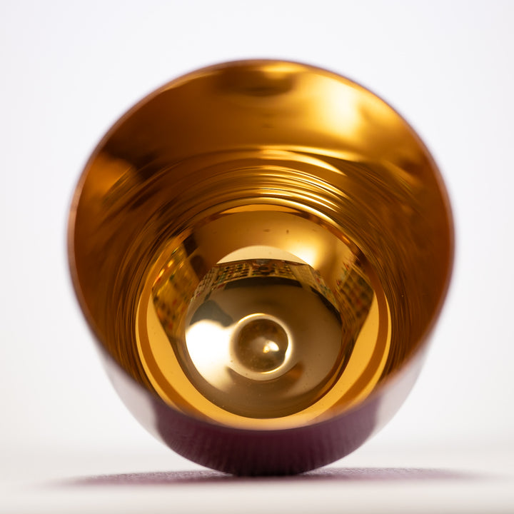Gold inside of a handheld singing bowl