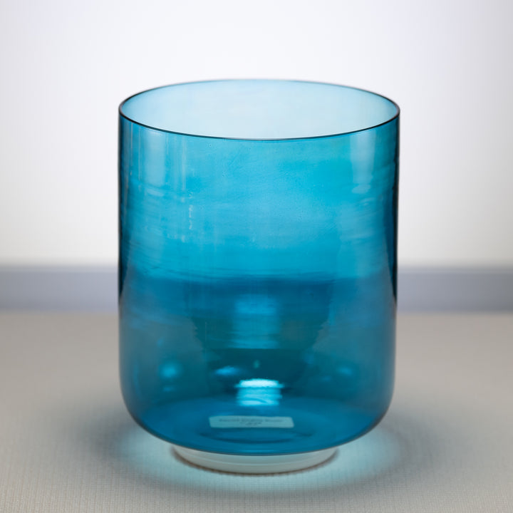 A 7-inch Caribbean Blue Crystal Singing Bowl with a visible base, placed on a flat surface.