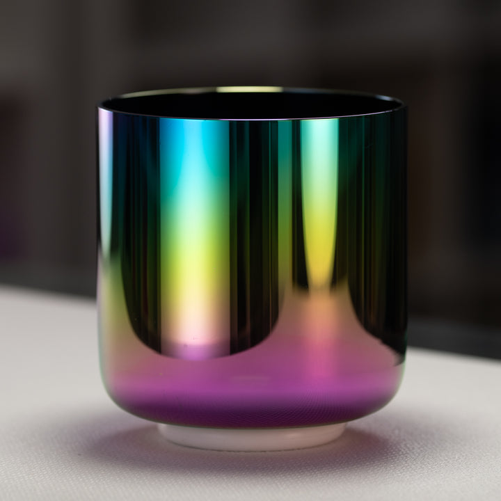 A 7-inch celestial rainbow singing bowl with iridescent hues of magenta, violet, pink, gold, and deep indigo.