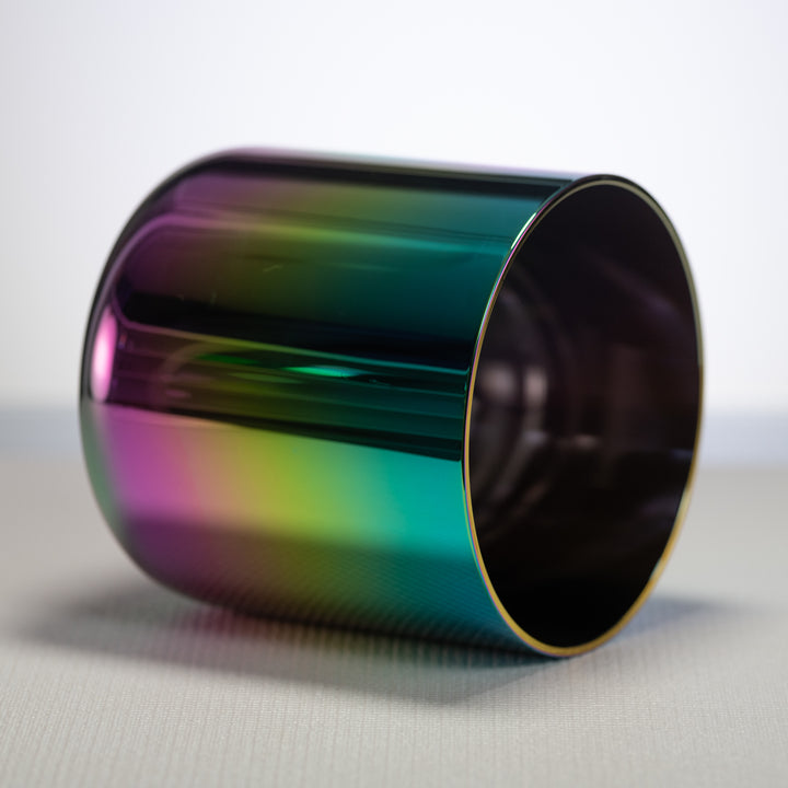 A 7-inch G#-47 Celestial Rainbow Singing Bowl with a reflective surface displaying iridescent hues of magenta, violet, pink, gold, and deep indigo.