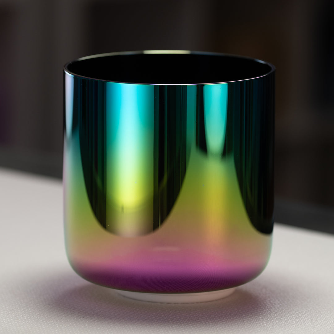 A 7-inch celestial rainbow singing bowl with iridescent hues of magenta, violet, pink, gold, and deep indigo.