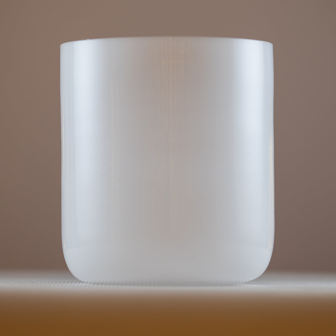 An 8.25 inch A-40 white light crystal singing bowl, with a clear and smooth surface, resonating with 215 Hz: 3rd octave.