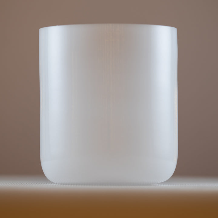 An 8.25 inch A-40 white light crystal singing bowl, with a clear and smooth surface, resonating with 215 Hz: 3rd octave.