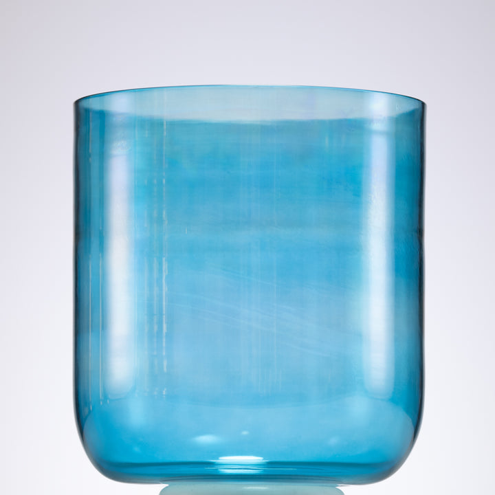 A Caribbean Blue Crystal Singing Bowl with a smooth, cylindrical shape displayed against a plain background.