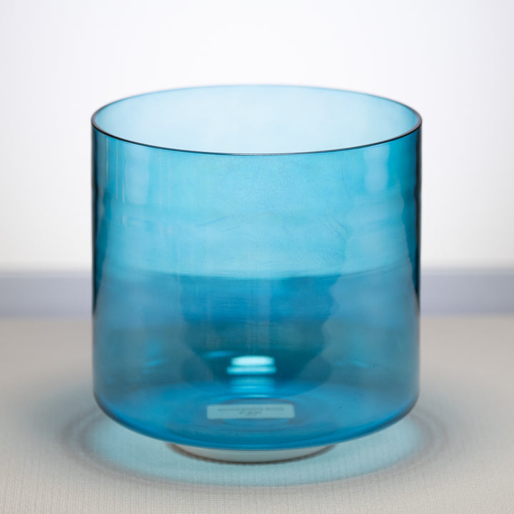 A Caribbean Blue Crystal Singing Bowl with a smooth, cylindrical shape displayed against a neutral background.