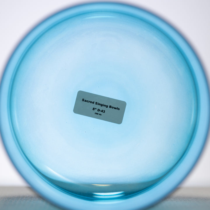 Caribbean Blue Crystal Singing Bowl with a label indicating it is an 8-inch D-43 bowl from Sacred Singing Bowls™