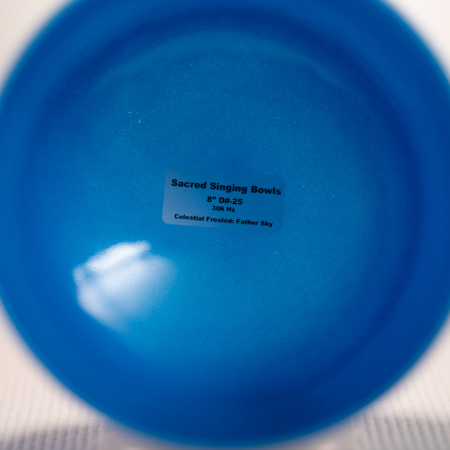 Blue singing bowl with a label on a white background