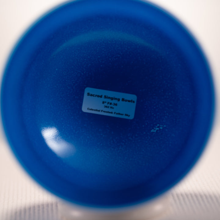 Blue singing bowl with a label on a white background