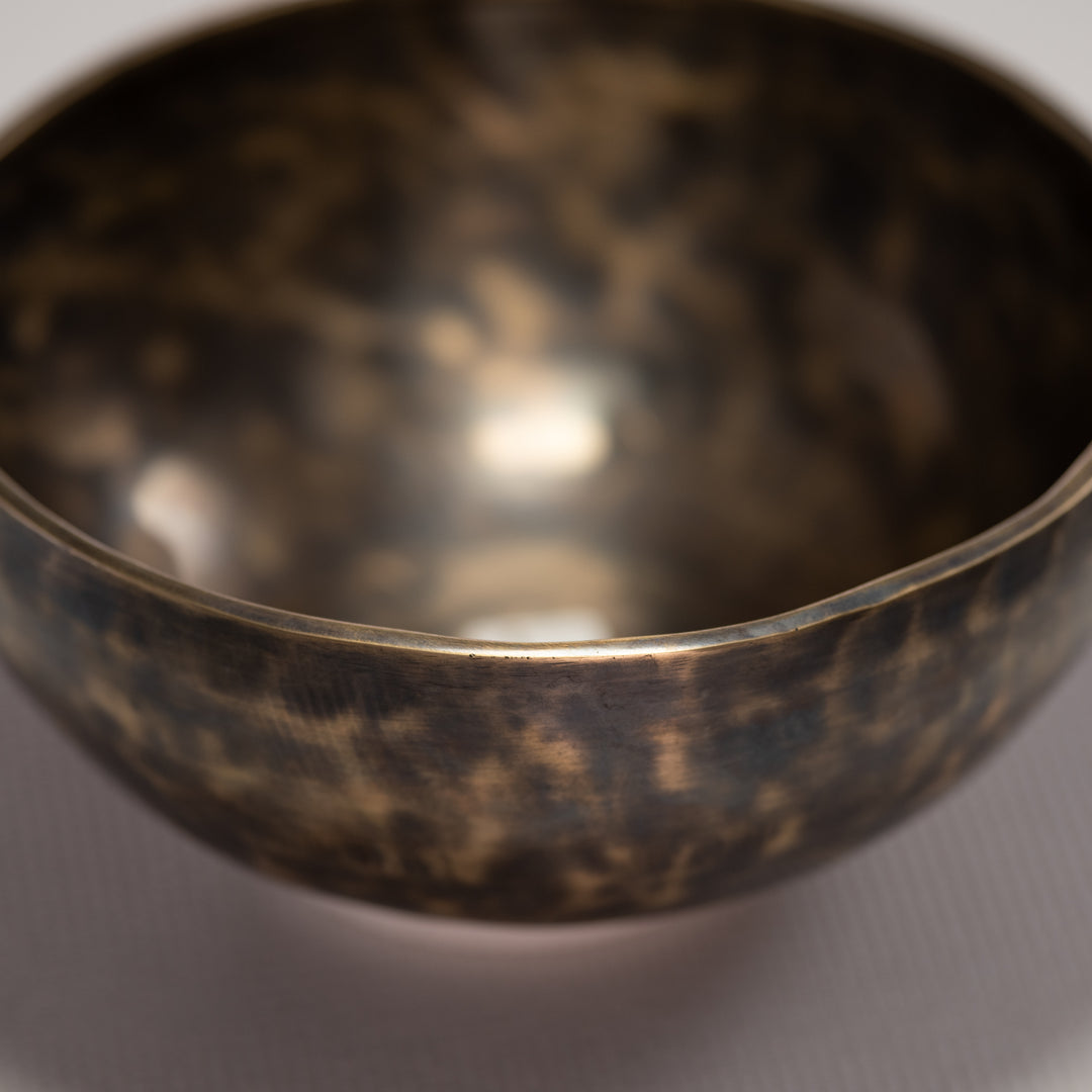 Close-up of a bronze bowl on a gray background
