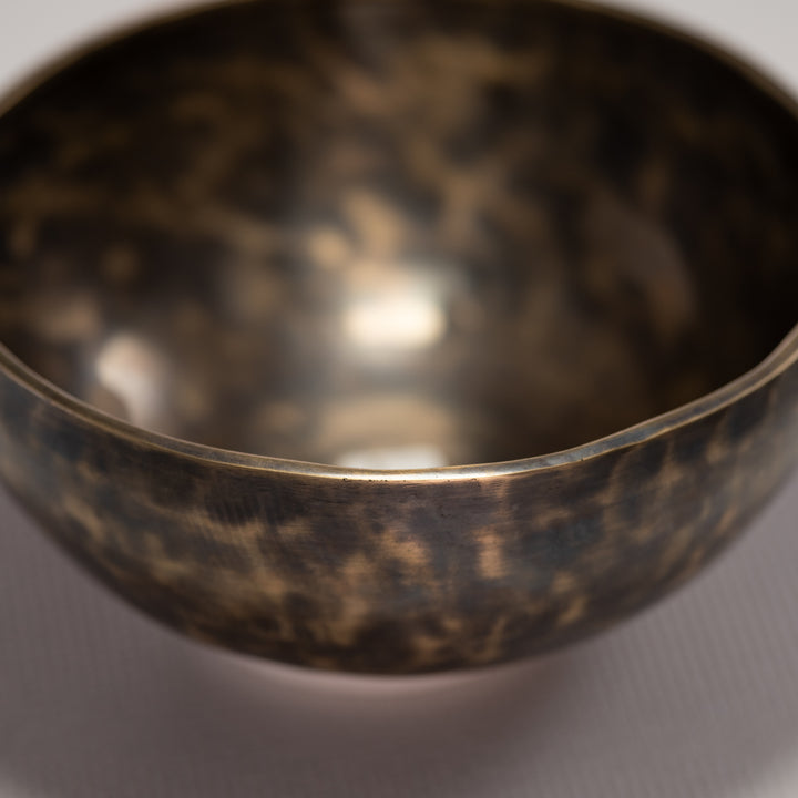 Close-up of a bronze bowl on a gray background